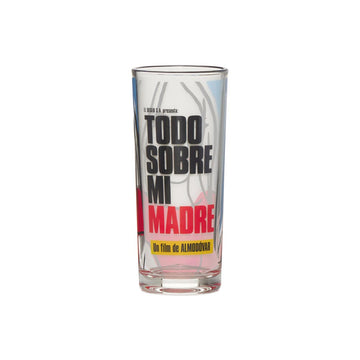 A clear drinking glass with text 'TODO SOBRE MI MADRE' printed on it, set against a plain background. The film ALL ABOUT MY MOTHER by director Pedro Almodovar